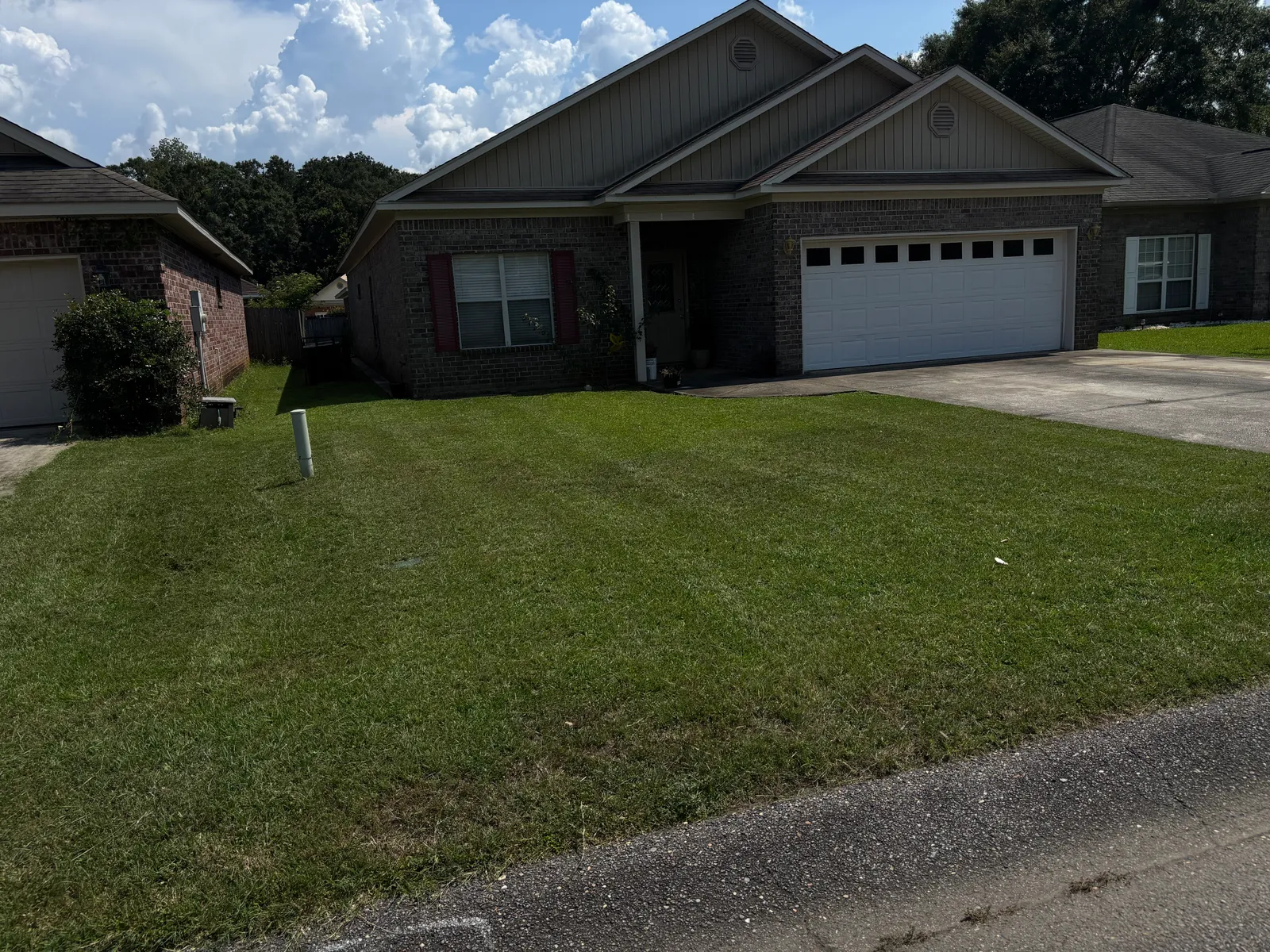 Maintained green lawn between brick homes